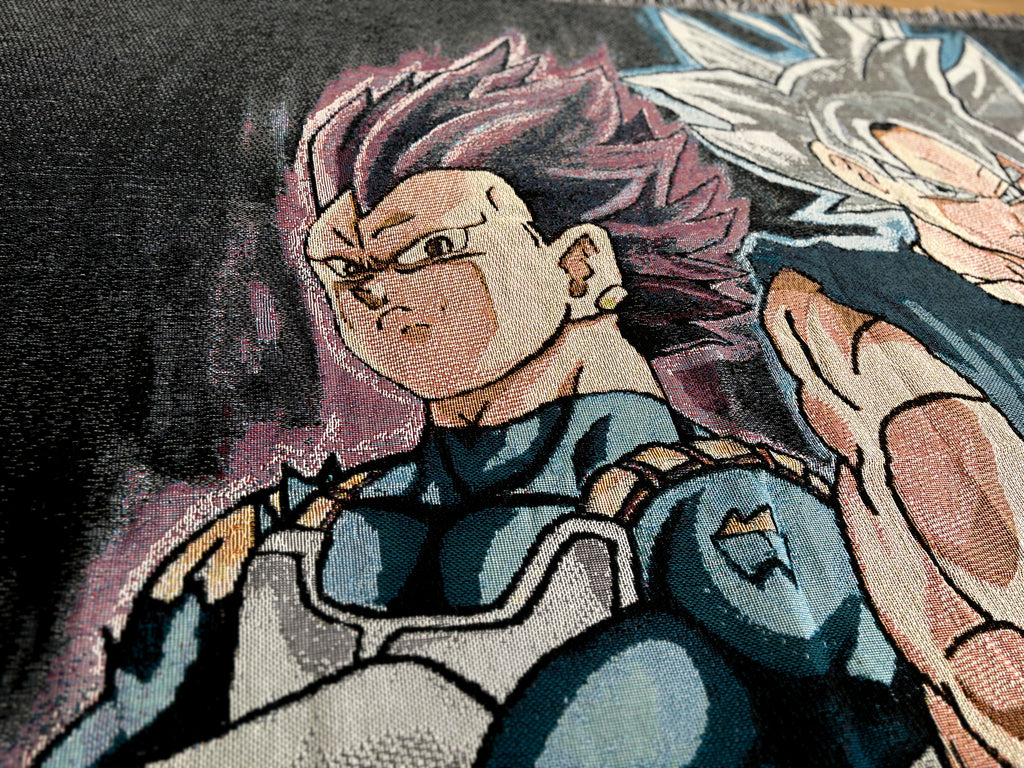 Close-up of a woven textile featuring anime-style characters, with the central figure having spiky pink hair and wearing blue and white armor, alongside another character with silver hair.