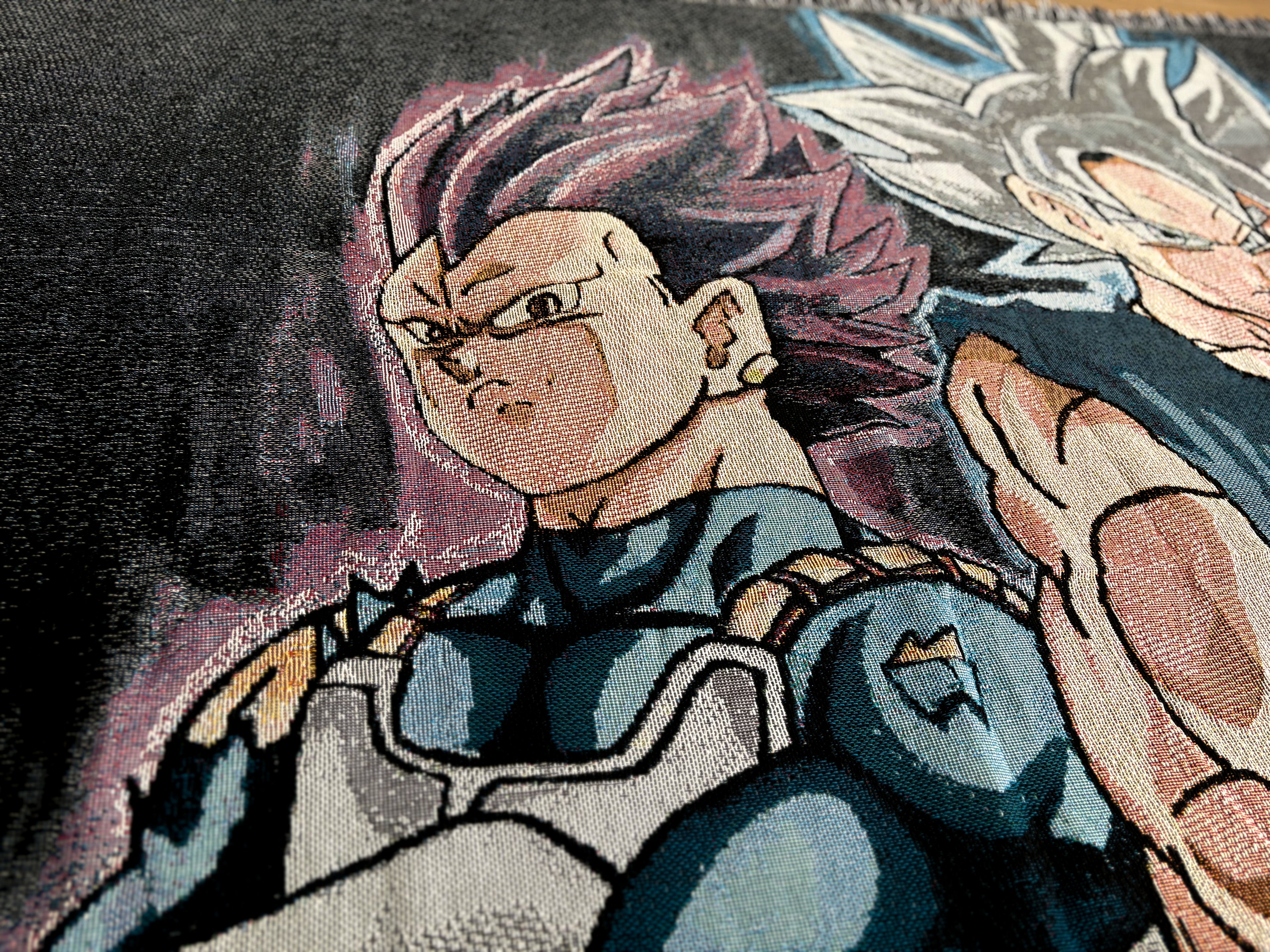 Close-up of a woven textile featuring anime-style characters, with the central figure having spiky pink hair and wearing blue and white armor, alongside another character with silver hair.